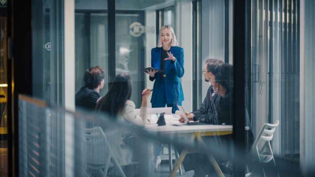 a women talking to people in office